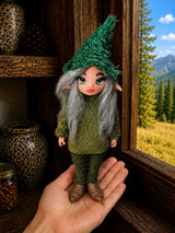 Maelira, Pixie of the Evergreen Pulse, handmade Pixie shown in hand for scale
