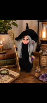 Mireva handmade Pixie holding a broom and amethyst on a botanical desk